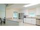 Bright kitchen with stainless steel appliances, sleek countertops, and an open connection to the dining room at 4725 Soapstone Dr, Tampa, FL 33615