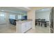 An open floorplan gives views to a living room, front door, and dining room from the kitchen at 4725 Soapstone Dr, Tampa, FL 33615