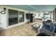 Screened-in patio features tile flooring, outdoor seating, and a refrigerator for outdoor convenience at 4725 Soapstone Dr, Tampa, FL 33615