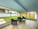 Screened patio with seating offers a view of the fenced-in yard and a shed for extra storage at 4725 Soapstone Dr, Tampa, FL 33615