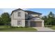 Charming two-story home featuring a covered entryway, attached garage, and well-maintained landscaping at 5670 Red Kite Dr, Wimauma, FL 33598