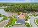 An aerial view of a lovely neighborhood with lush greenery, water, and inviting backyard pools at 630 Lake Cypress Cir, Oldsmar, FL 34677
