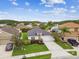 An aerial view of the home featuring beautiful landscaping, a long driveway, and a two-car garage at 630 Lake Cypress Cir, Oldsmar, FL 34677