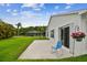 Relaxing backyard patio with chair, lush landscaping and a serene view of the lake at 630 Lake Cypress Cir, Oldsmar, FL 34677