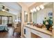 Bathroom with a sink, vanity, mirror and an open view to the main bedroom at 630 Lake Cypress Cir, Oldsmar, FL 34677