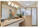 Bathroom featuring a glass enclosed shower, a vanity with a mirror, and a sink at 630 Lake Cypress Cir, Oldsmar, FL 34677