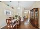 Elegant dining room featuring hardwood floors, a chandelier, and a dining table for six at 630 Lake Cypress Cir, Oldsmar, FL 34677