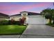 Charming single-Gathering home with well-maintained lawn and landscaped front yard, featuring a two-car garage at 630 Lake Cypress Cir, Oldsmar, FL 34677