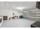 Spacious garage featuring an automatic door, ample storage space and a clean, painted floor at 630 Lake Cypress Cir, Oldsmar, FL 34677