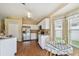 Bright kitchen with stainless steel appliances, white cabinets, and an adjacent breakfast nook at 630 Lake Cypress Cir, Oldsmar, FL 34677