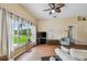 Bright living room with hardwood floors, large window, and comfortable seating for relaxing at 630 Lake Cypress Cir, Oldsmar, FL 34677