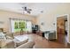 Bright living room with hardwood floors, large window, and comfortable seating for relaxing at 630 Lake Cypress Cir, Oldsmar, FL 34677