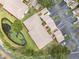 Aerial view of condo buildings, a pond, and the surrounding community showcasing the well-maintained landscaping and serene environment at 6330 99Th N Way # 14B, Seminole, FL 33708