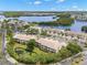 A birds eye view of the condo community surrounded by trees and pond creating a private retreat at 6330 99Th N Way # 14B, Seminole, FL 33708