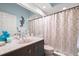 Bathroom with a single vanity, mirrored medicine cabinet and decorative shower curtain at 6330 99Th N Way # 14B, Seminole, FL 33708