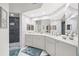 Modern bathroom featuring dual sinks, large mirrors, and a luxurious shower with dark tile surround at 6330 99Th N Way # 14B, Seminole, FL 33708