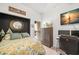 Stylishly appointed bedroom with a dark accent wall, a comfortable bed, and a well-lit workspace at 6330 99Th N Way # 14B, Seminole, FL 33708