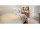 Bedroom featuring a warm yellow bedspread and wood dresser with views to the bathroom and entry at 6330 99Th N Way # 14B, Seminole, FL 33708