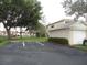Exterior of home with adjacent parking, landscaping, and mature shade trees at 6330 99Th N Way # 14B, Seminole, FL 33708