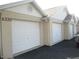 Attached garage doors on an apartment complex with visible address numbers on stucco siding at 6330 99Th N Way # 14B, Seminole, FL 33708