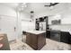 Modern kitchen featuring a center island with countertop seating, stainless steel appliances, and ample storage at 6330 99Th N Way # 14B, Seminole, FL 33708