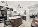 Bright kitchen featuring stainless steel appliances, a stylish island, and modern black and white cabinetry at 6330 99Th N Way # 14B, Seminole, FL 33708