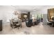 Open-concept living room with a dining table, entertainment center, and sliding glass doors to the screened porch at 6330 99Th N Way # 14B, Seminole, FL 33708