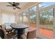 Enclosed patio featuring a ceiling fan and an elegant dining set with scenic views of the outdoors at 6330 99Th N Way # 14B, Seminole, FL 33708