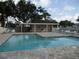 Community pool with restroom area and plenty of poolside seating at 6330 99Th N Way # 14B, Seminole, FL 33708