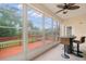 Enclosed and screened porch overlooking the backyard featuring a bar and seating with a ceiling fan at 6330 99Th N Way # 14B, Seminole, FL 33708