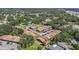 Aerial view of condo community nestled among mature trees in a residential area at 6346 Bonnie Bay N Cir, Pinellas Park, FL 33781