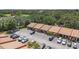 Aerial view of property with ample parking, and surrounding landscaping at 6346 Bonnie Bay N Cir, Pinellas Park, FL 33781