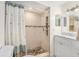 Bathroom with a stone tiled shower and neutral colored walls at 6346 Bonnie Bay N Cir, Pinellas Park, FL 33781