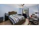 A blue bedroom featuring a large tufted bed and neutral colored vinyl floors at 6346 Bonnie Bay N Cir, Pinellas Park, FL 33781