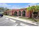 Inviting villa showcasing an arched entry, lush lawn, and convenient parking at 6346 Bonnie Bay N Cir, Pinellas Park, FL 33781