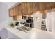 Bright kitchen featuring wood cabinets and modern black appliances at 6346 Bonnie Bay N Cir, Pinellas Park, FL 33781