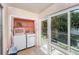 Small laundry room with newer washer/dryer set and view of backyard at 6346 Bonnie Bay N Cir, Pinellas Park, FL 33781