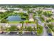 Community aerial view showcases pond, lush greenery, parking, and well-maintained townhomes at 6706 47Th N St, Pinellas Park, FL 33781