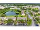 Community aerial view showcases pond, lush greenery, parking, and well-maintained townhomes at 6706 47Th N St, Pinellas Park, FL 33781