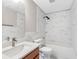 Bright bathroom features marble-style wall tiles, with tub-shower combo and a modern vanity sink at 6706 47Th N St, Pinellas Park, FL 33781