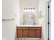 Bathroom featuring a double sink vanity with storage and a well-lit mirror at 6706 47Th N St, Pinellas Park, FL 33781