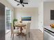 Cozy dining area with a round wood table, comfortable seating, and natural light from sliding glass door at 6706 47Th N St, Pinellas Park, FL 33781