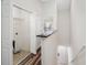 Hallway view featuring a laundry room, wood floors and a stairway leading to an entryway at 6706 47Th N St, Pinellas Park, FL 33781