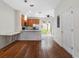 Open floor plan showcasing the kitchen and dining area with hardwood flooring and modern lighting at 6706 47Th N St, Pinellas Park, FL 33781