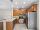 Functional kitchen with stainless steel appliances, wooden cabinets, and tiled flooring at 6706 47Th N St, Pinellas Park, FL 33781