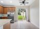 Modern kitchen with stainless steel appliances and a sliding glass door leading to the backyard at 6706 47Th N St, Pinellas Park, FL 33781