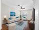 Bright living room featuring a modern ceiling fan, plush seating, and stylish decor at 6706 47Th N St, Pinellas Park, FL 33781