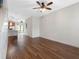 Spacious living room featuring hardwood floors, ceiling fan and seamless access to the kitchen at 6706 47Th N St, Pinellas Park, FL 33781