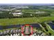 Aerial view of a house surrounded by well-manicured lawns and close to community amenities with lush greenery at 6932 Old Benton Dr, Apollo Beach, FL 33572