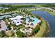 A stunning aerial view of the community pool and clubhouse surrounded by lakes and lush landscaping, ideal for relaxation and recreation at 6932 Old Benton Dr, Apollo Beach, FL 33572